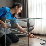 Asian cleaning service woman worker cleaning in living room at home. Beautiful young girl